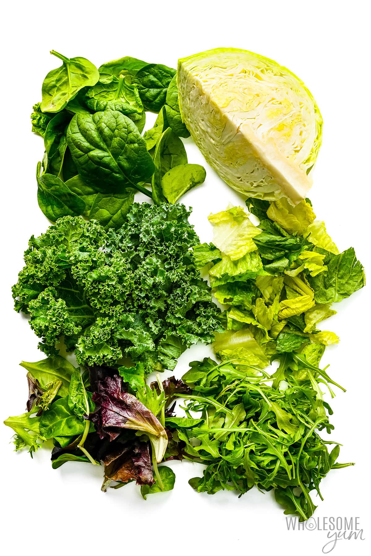Keto leafy vegetables on white background.