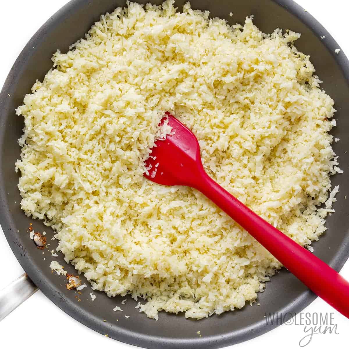 Cauliflower rice stir fried in pan.