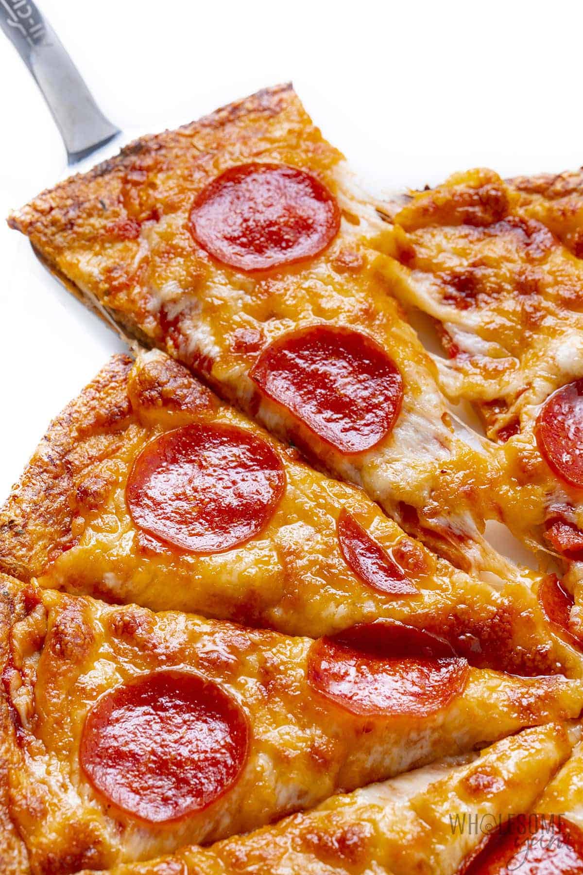 Baked cauliflower pizza crust with toppings.