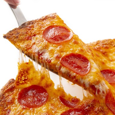 Cauliflower pizza crust with cheese pull.