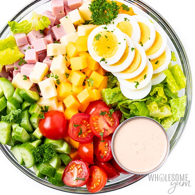 Chef salad recipe in a bowl with dressing on the side