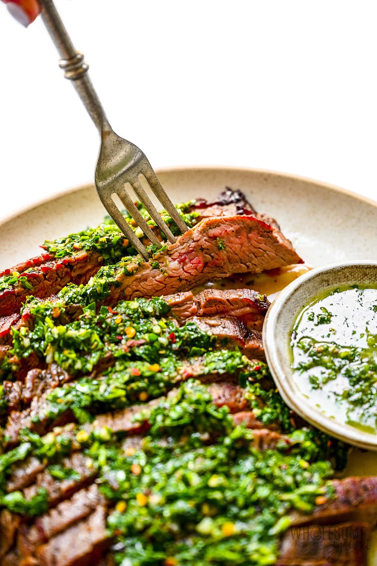 Chimichurri steak with fork.