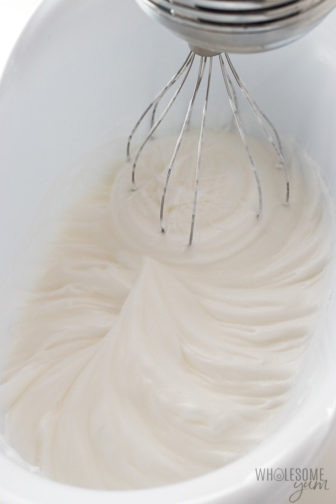 Whipping egg whites to stiff peaks.