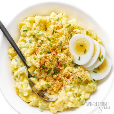 Egg salad recipe in a bowl with sliced egg garnish.