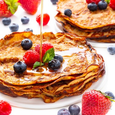 Cream cheese pancakes topped with berries and syrup