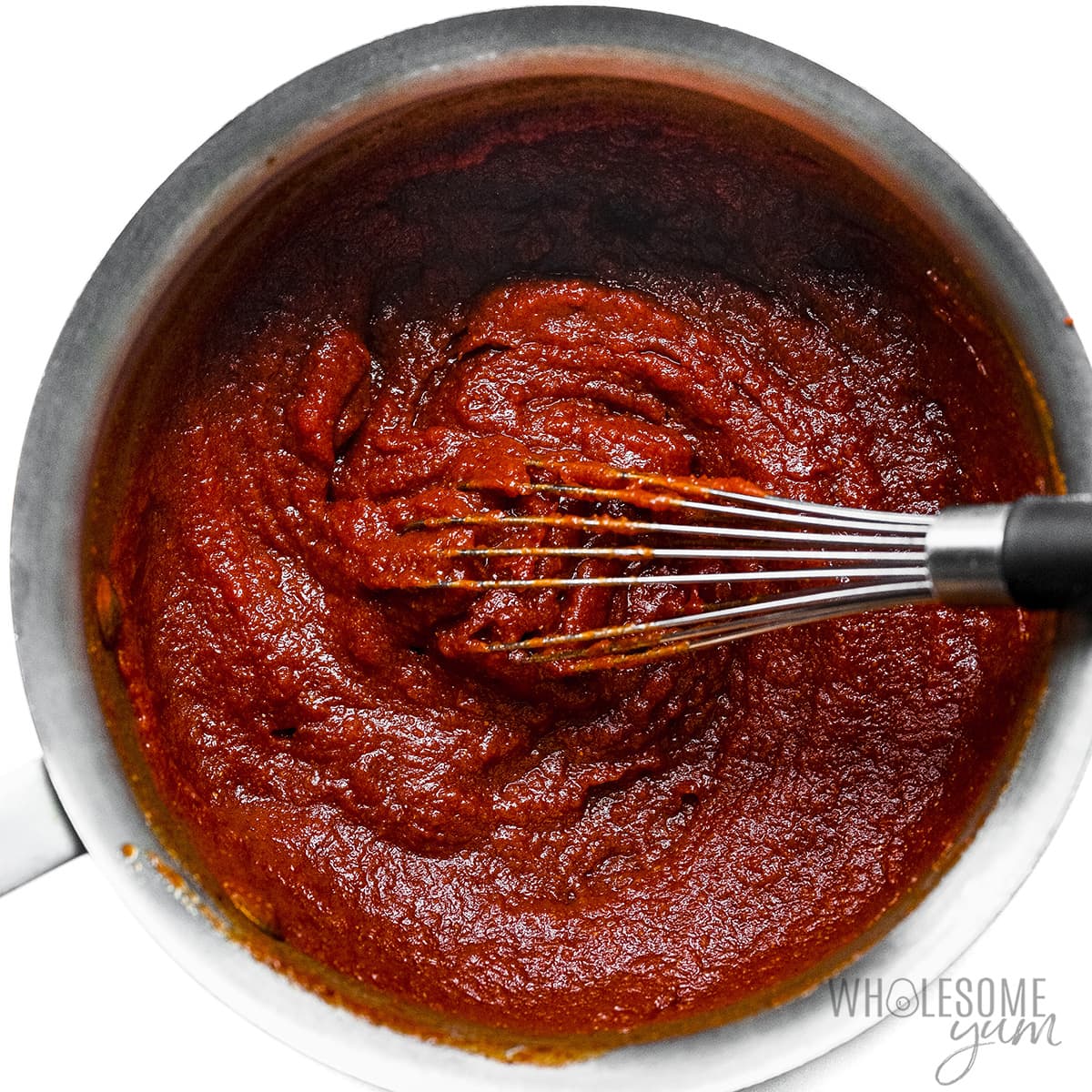 Ingredients whisked into a saucepan.