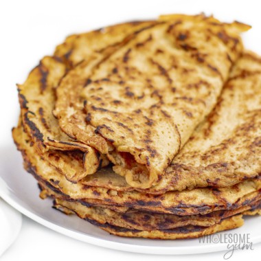 Coconut flour tortillas folded over on a stack of more coconut wraps.