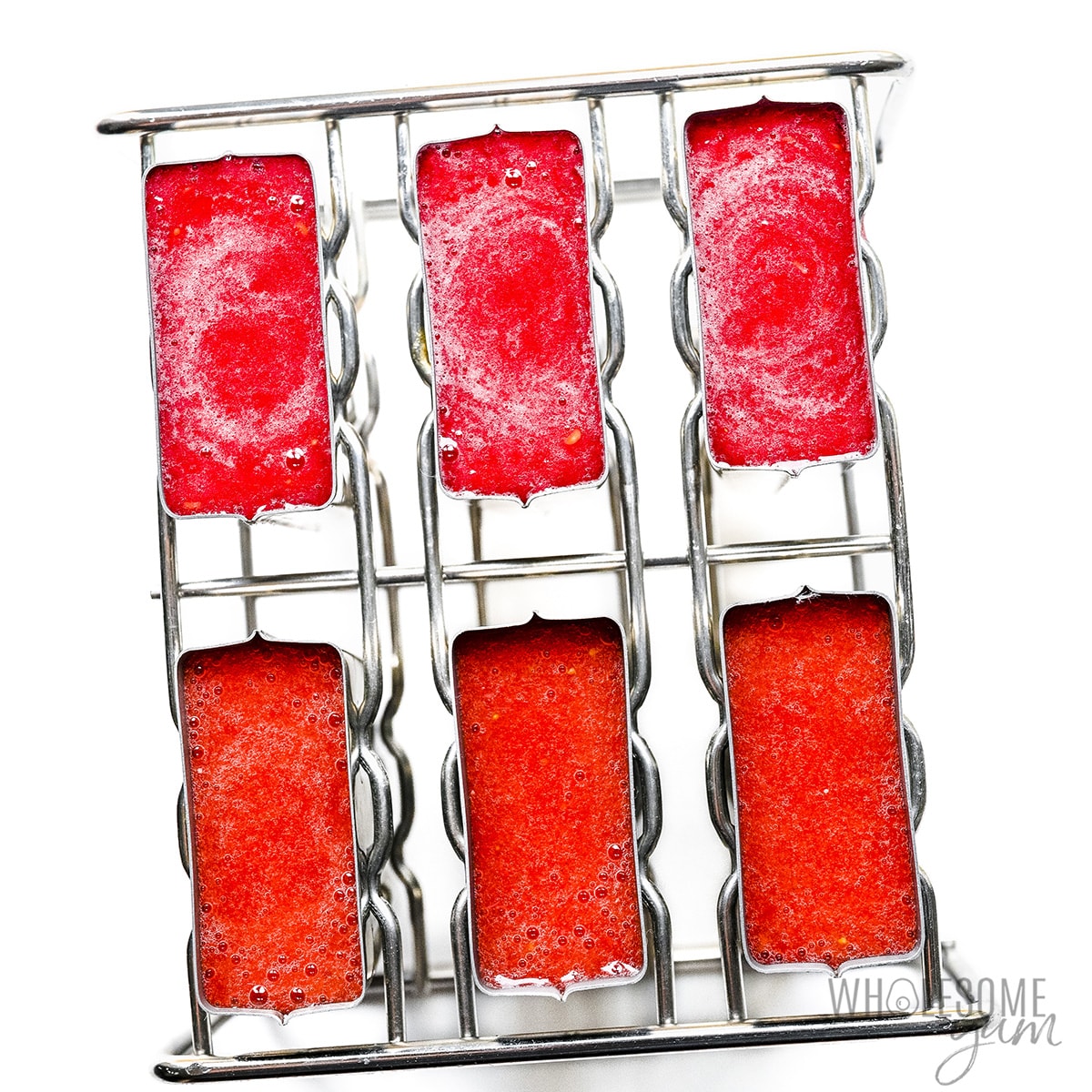 Popsicle juice poured into molds.