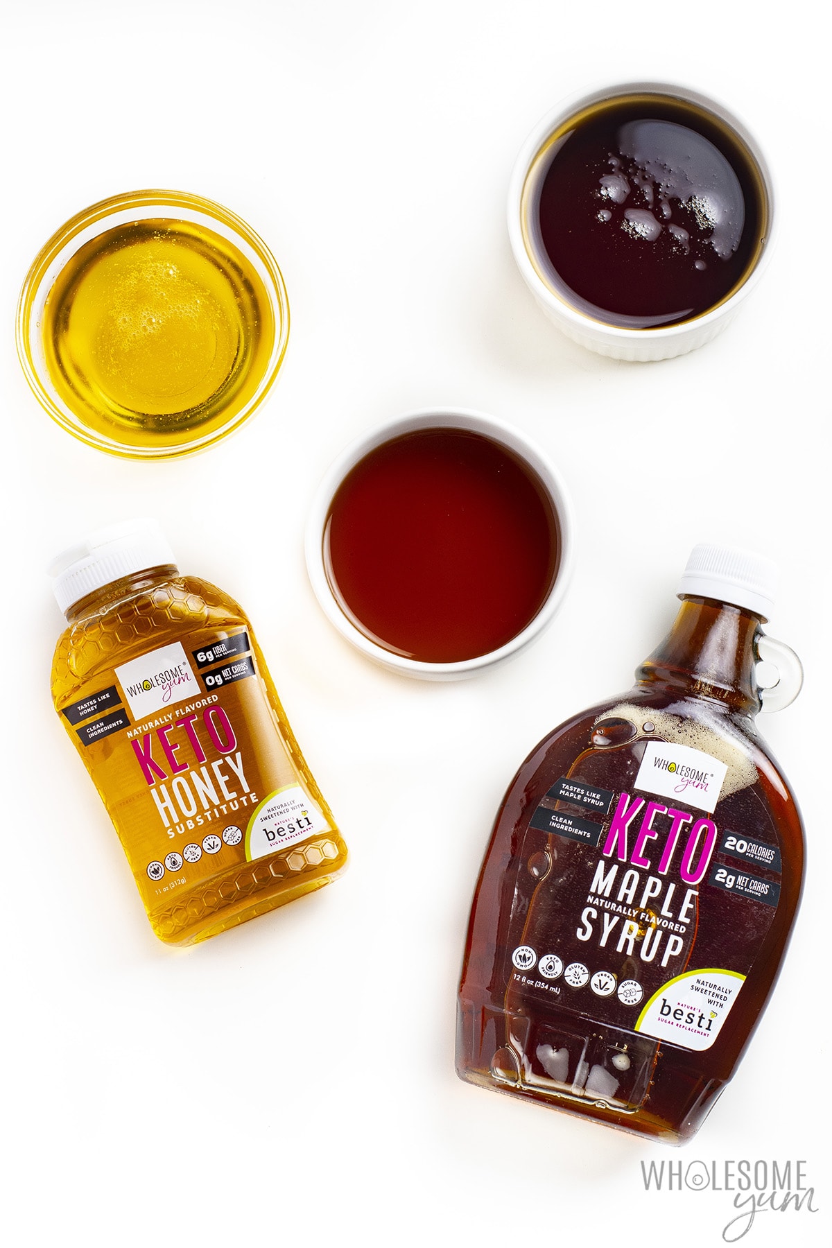 Keto honey and maple syrup, with more liquid sweeteners in bowls.