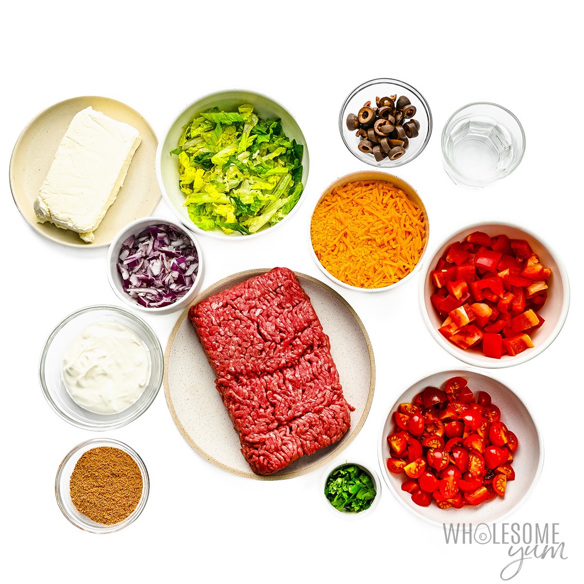 Taco dip ingredients in bowls.