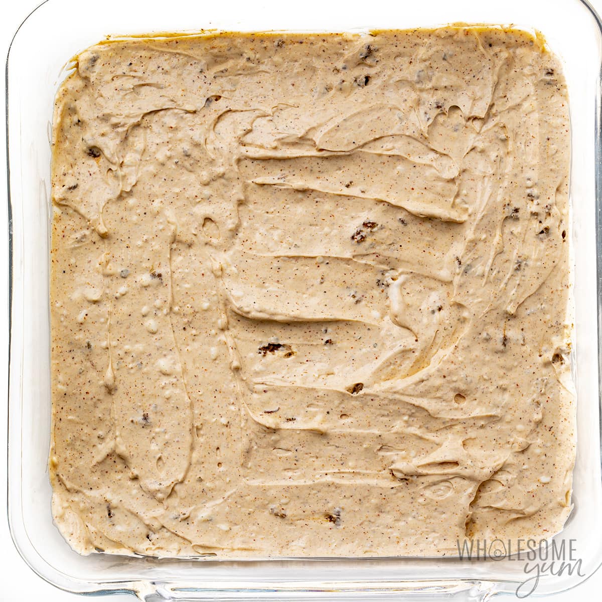 Ground beef and cream cheese mixture layered in baking dish.